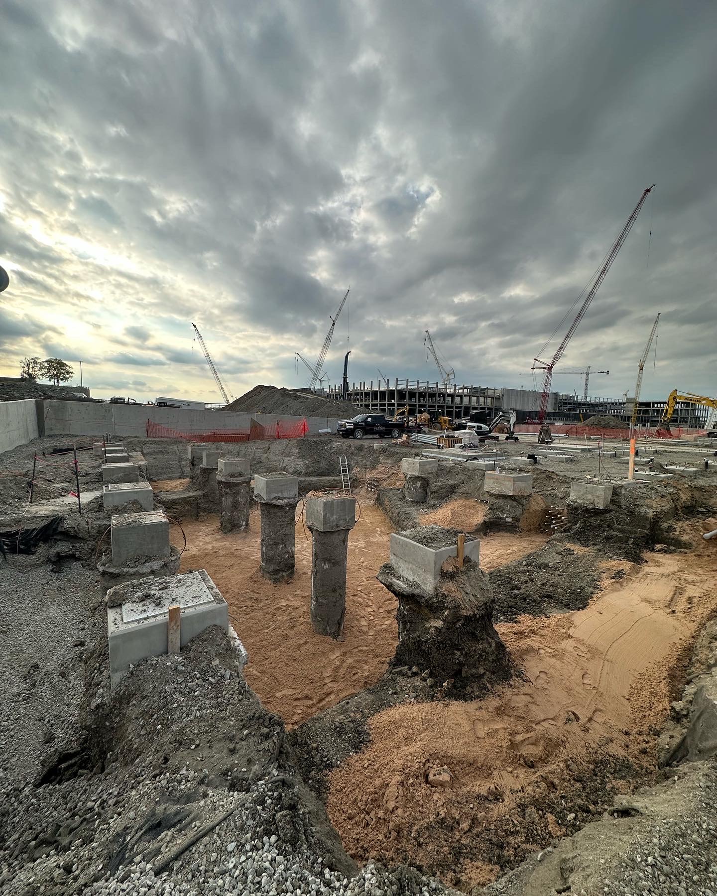 Completed drilled shaft foundations and pile caps on an active construction site