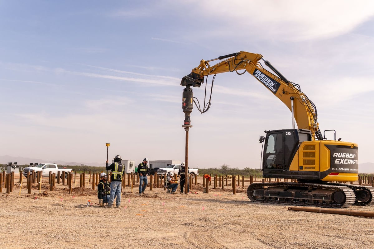 Helical pile installation with Rueben Excavation drive head and survey crew