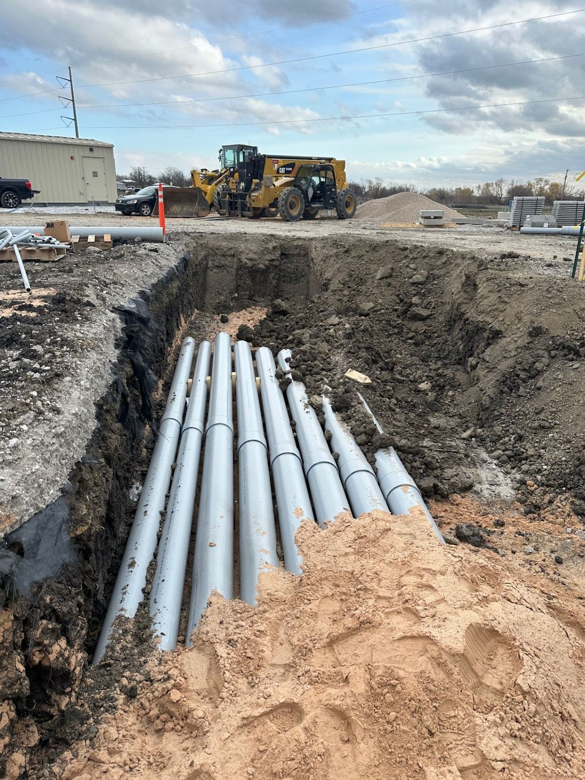 PVC duct bank conduits installed in open trench at energy infrastructure site