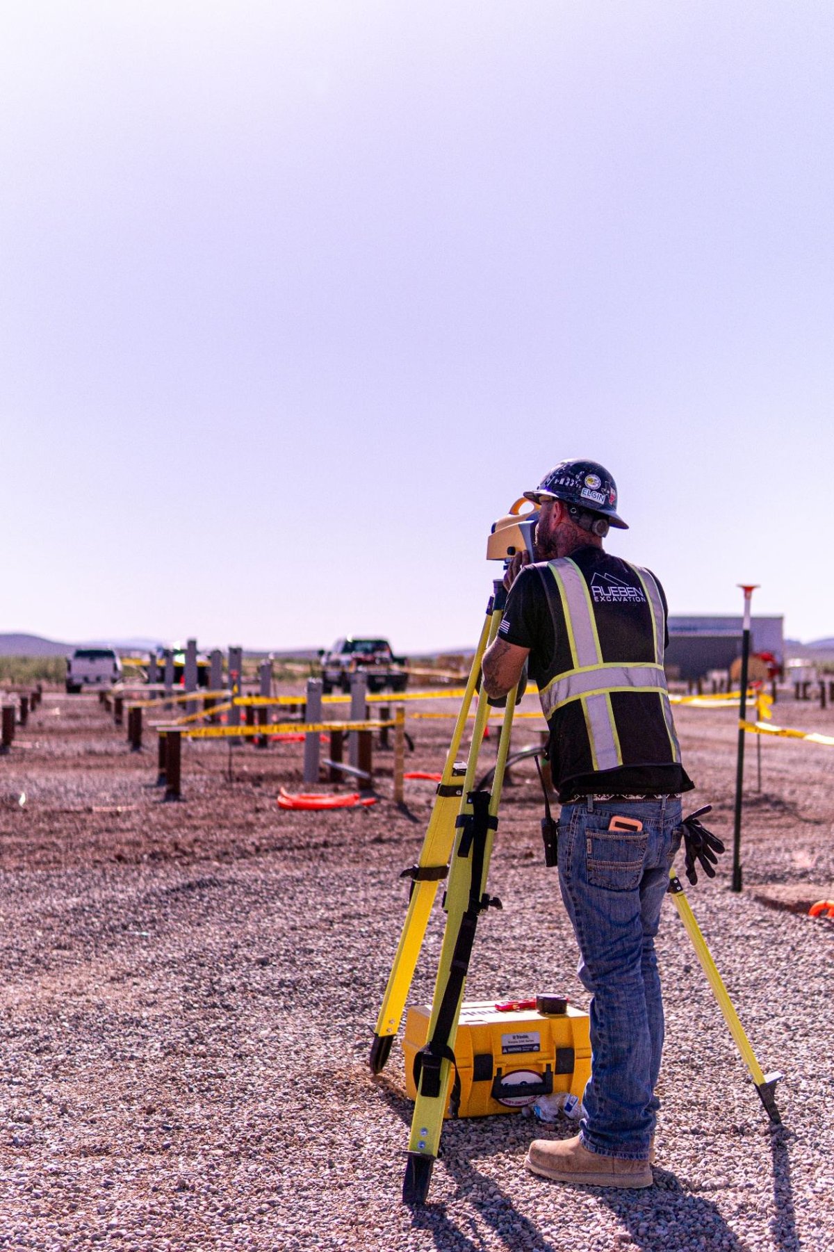 Rueben Excavation surveyor running total station for pile foundation layout