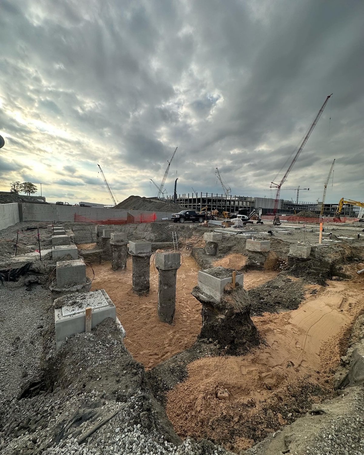 Completed drilled shaft foundations and pile caps on an active construction site