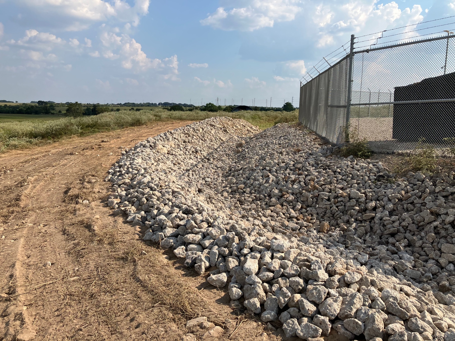 Rip-rap erosion control along substation perimeter fence
