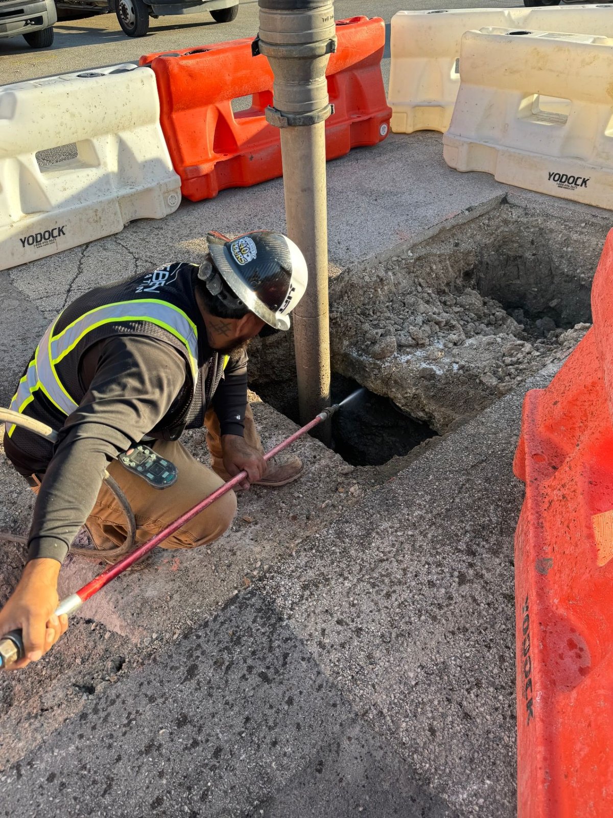 Rueben Group crew member performing hydrovac potholing to safely expose underground utilities