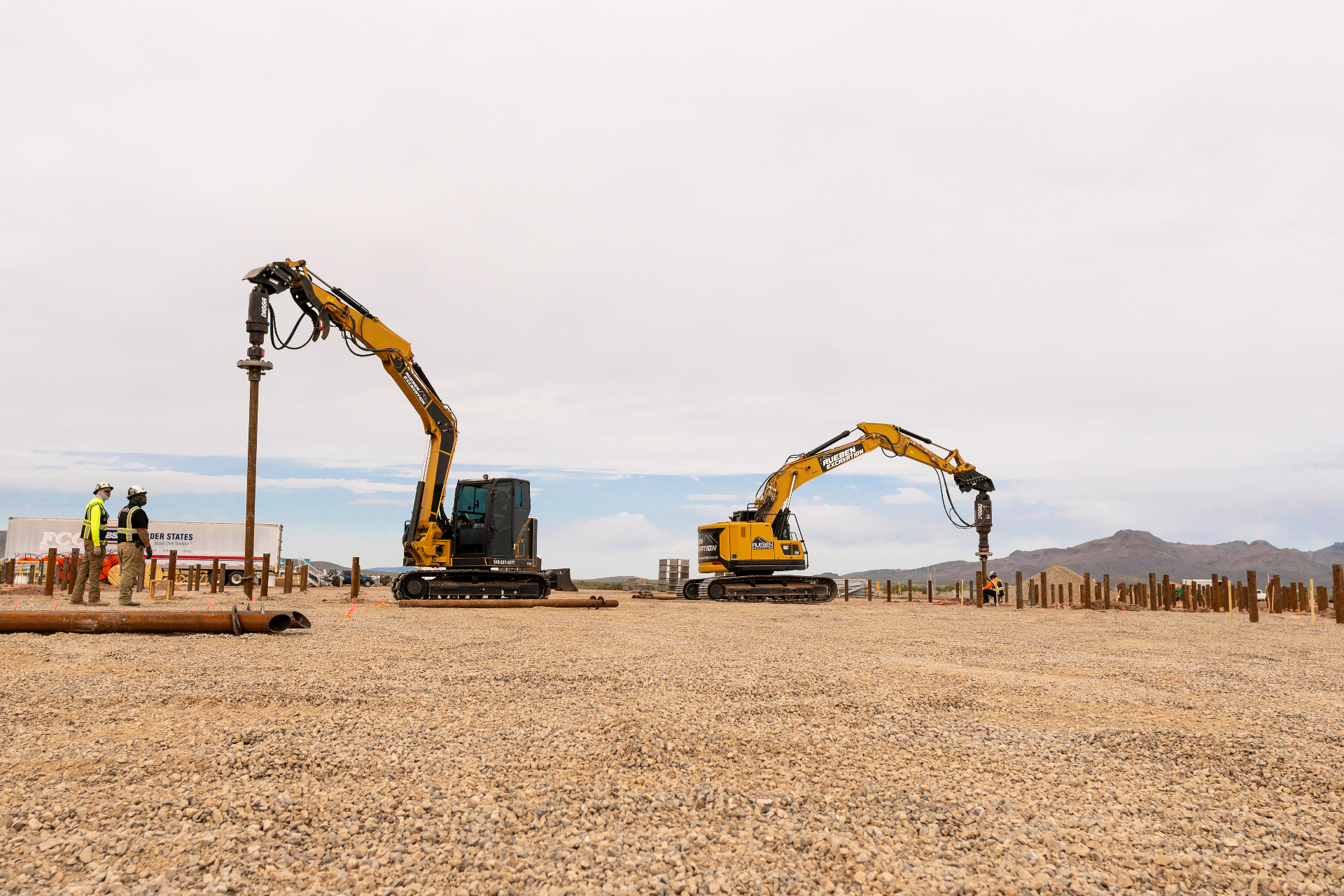 Rueben Excavation helical pile driving rigs installing foundation piles on utility-scale site