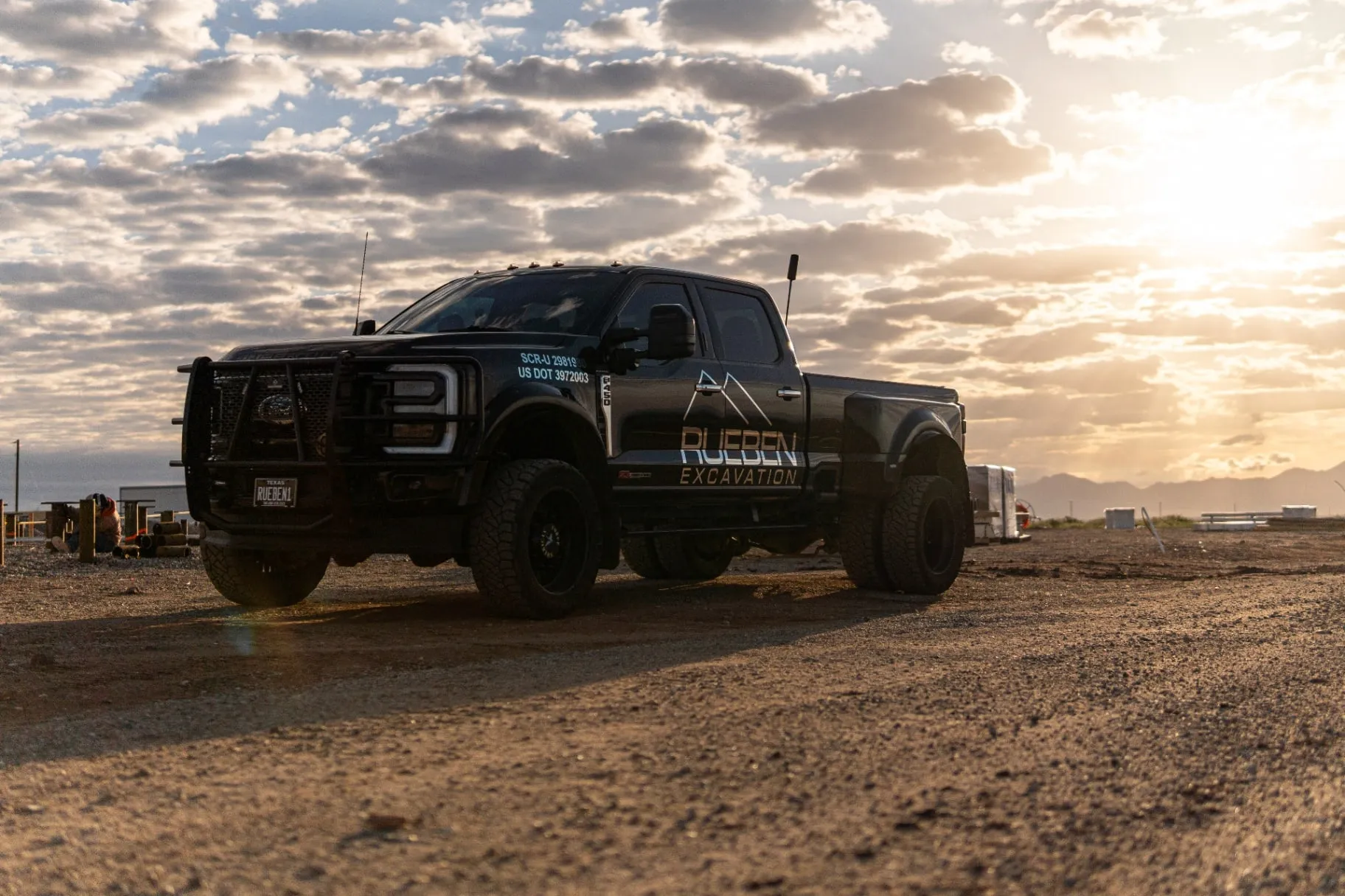 Rueben Excavation truck at sunset on a project site
